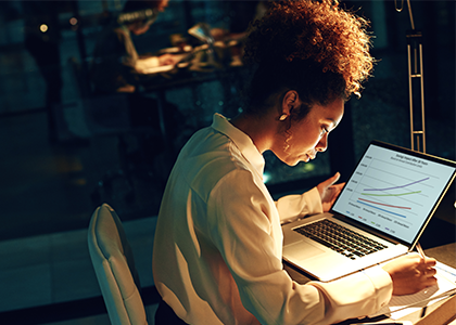 Woman looking at graphs on a computer