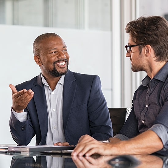 three people listening and taking notes